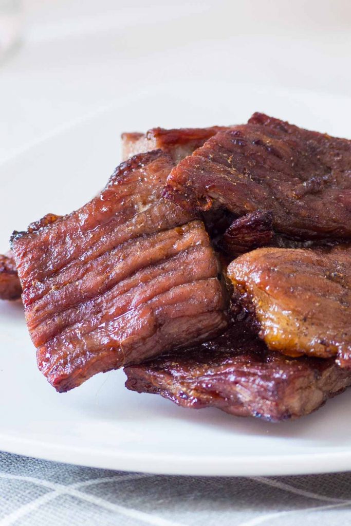 Thai beef jerky or nuea kemon a white plate