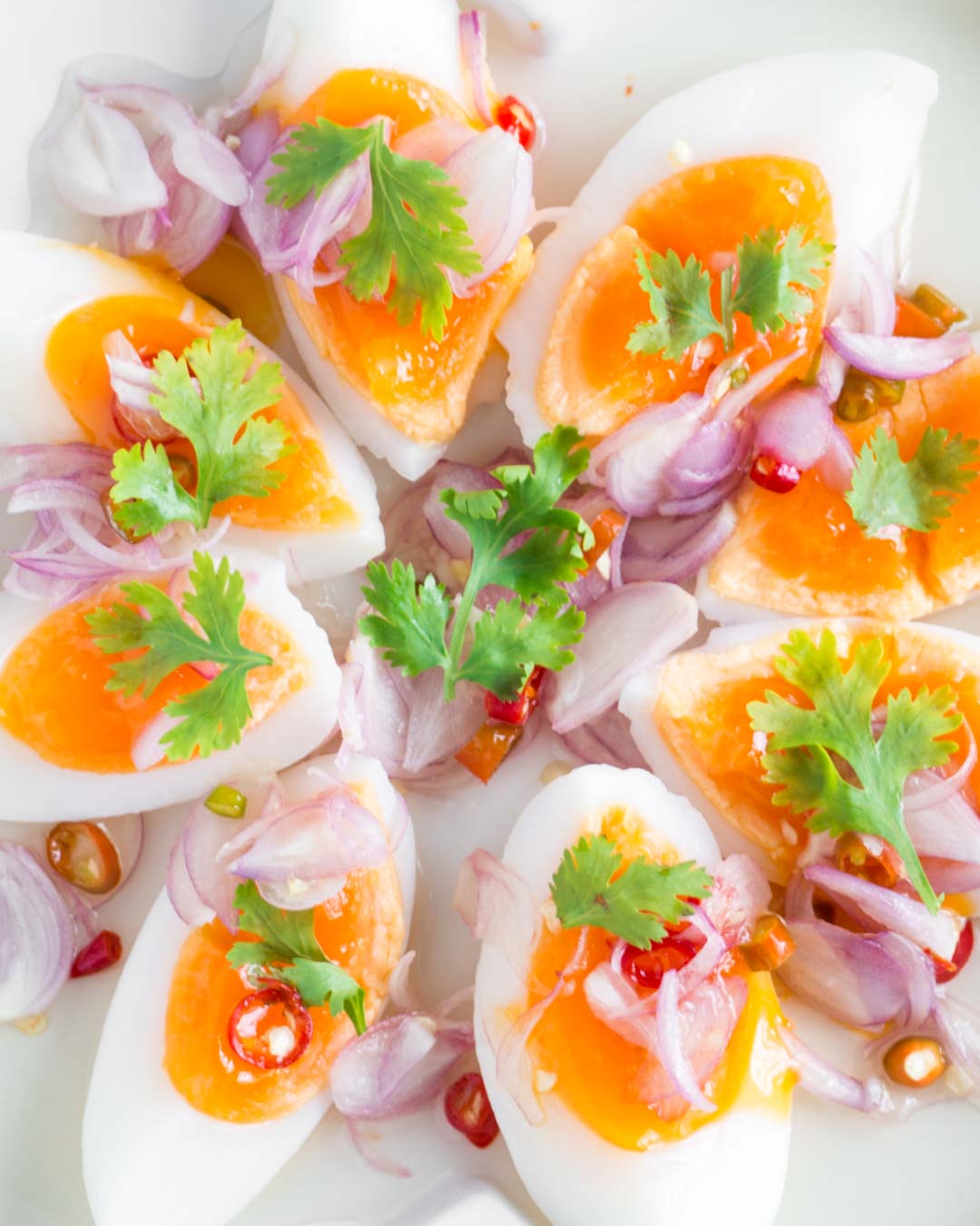 thai medium boiled egg salad on a white plate