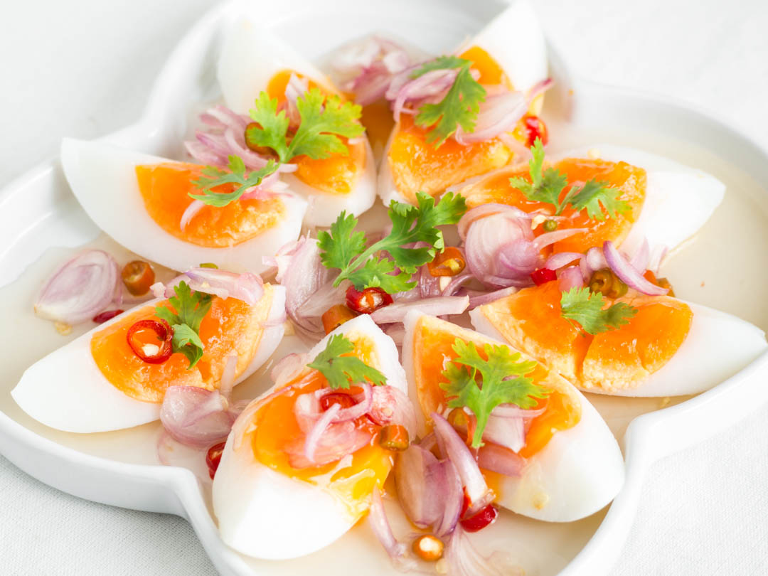 thai medium boiled egg salad on a white plate