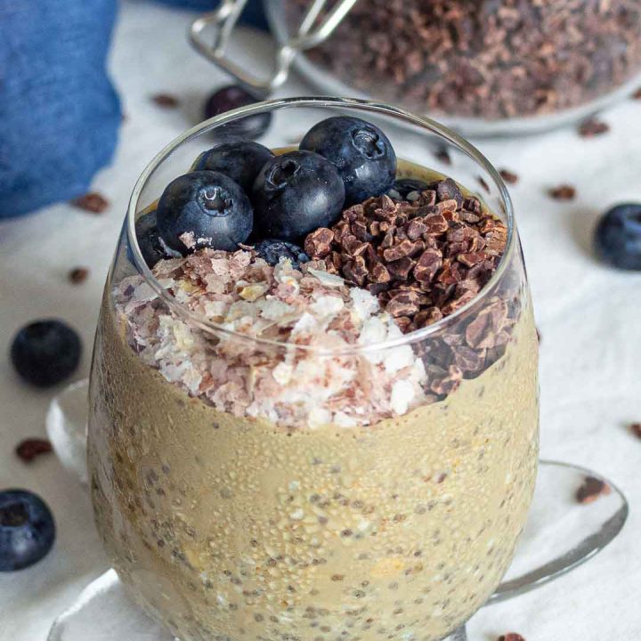 overnight oats with cacao nibs, blueberries and brown rice flakes in a glass