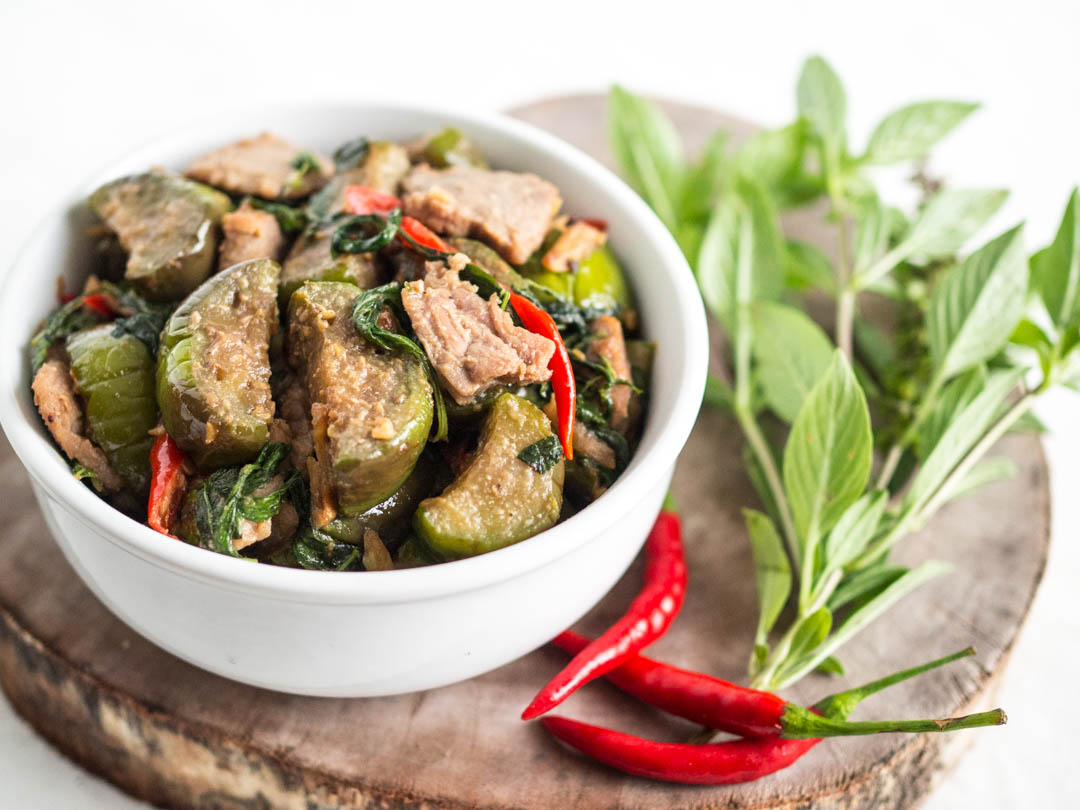 a bowl of thai eggplant stir-fried with salted soy beans and Thai basil