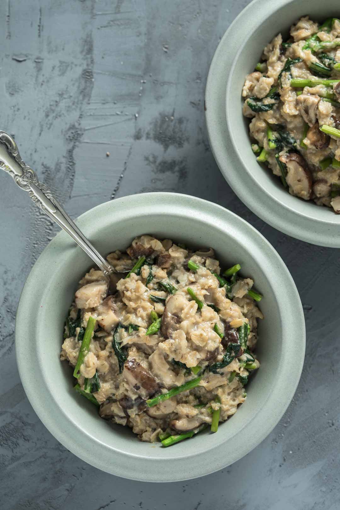 two bowls of savory oatmeal with vegetables