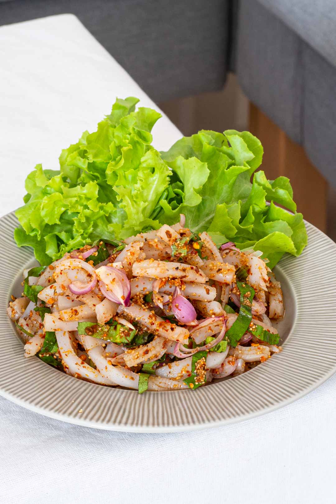 a plate of Thai vegan larb (laab) with konjac noodles on a table