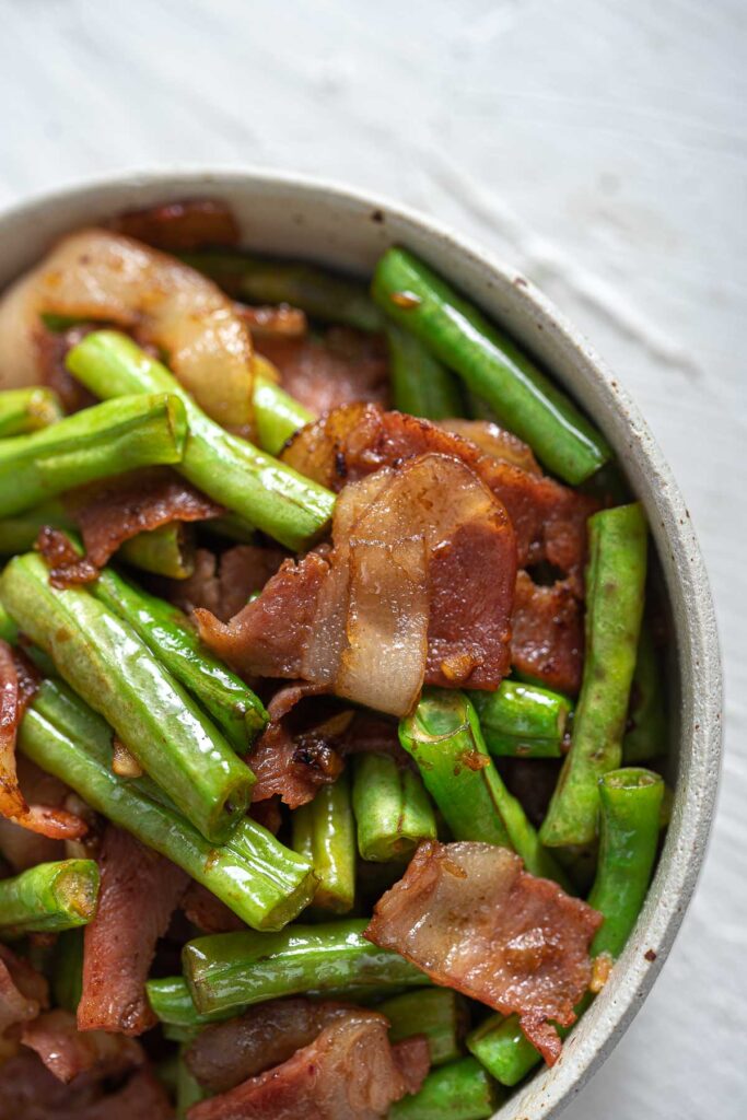 Chinese long bean stir fry with garlic and bacon in a bowl