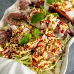 Thai steamed squid with lime chili garlic sauce in a serving dish