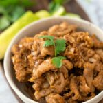 Thai garlic pepper pork in a white bowl