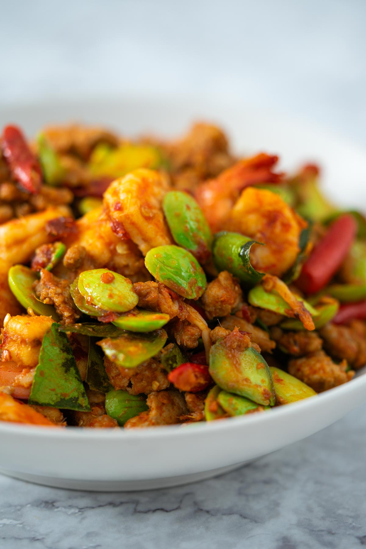 Thai stir fried stink beans with shrimp in a white dish