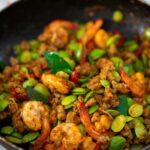 Thai stir fried stink beans with shrimp in a frying pan