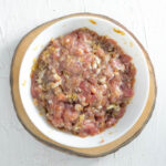 Thai marinated ground pork in a white bowl