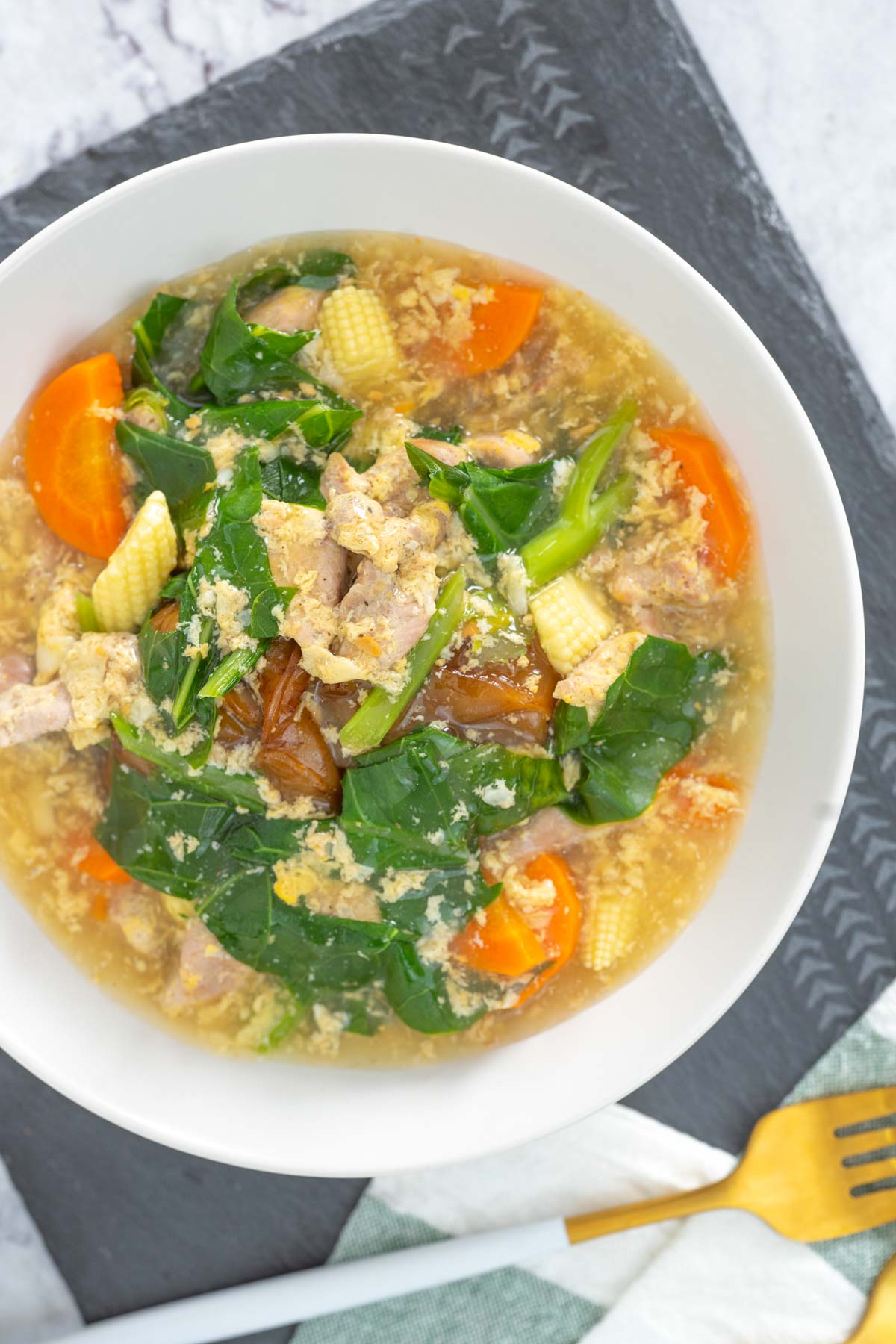 Thai rad na sticky rice noodles with pork gravy served in a white bowl