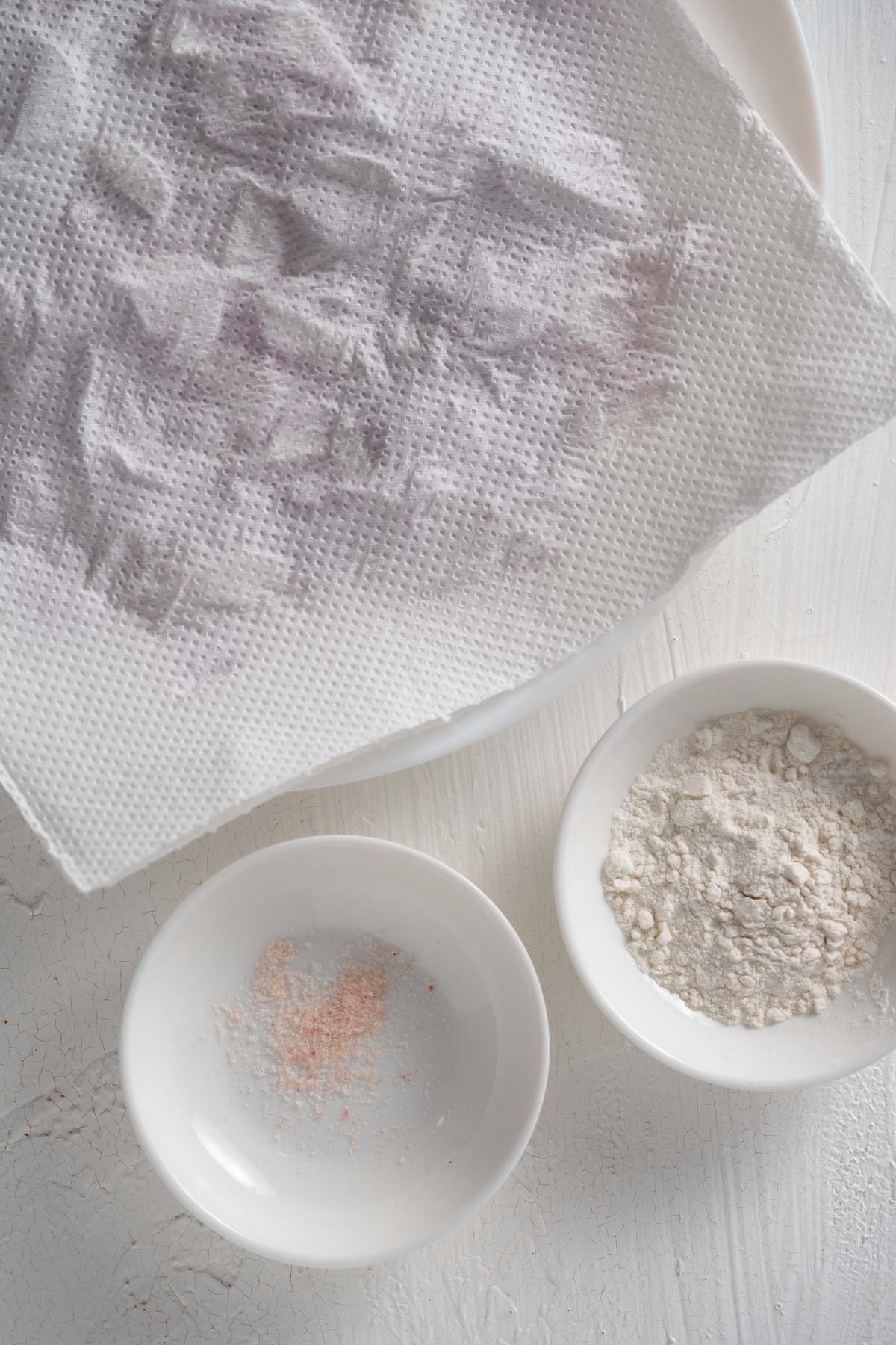 shallots, salt and flour on a white surface