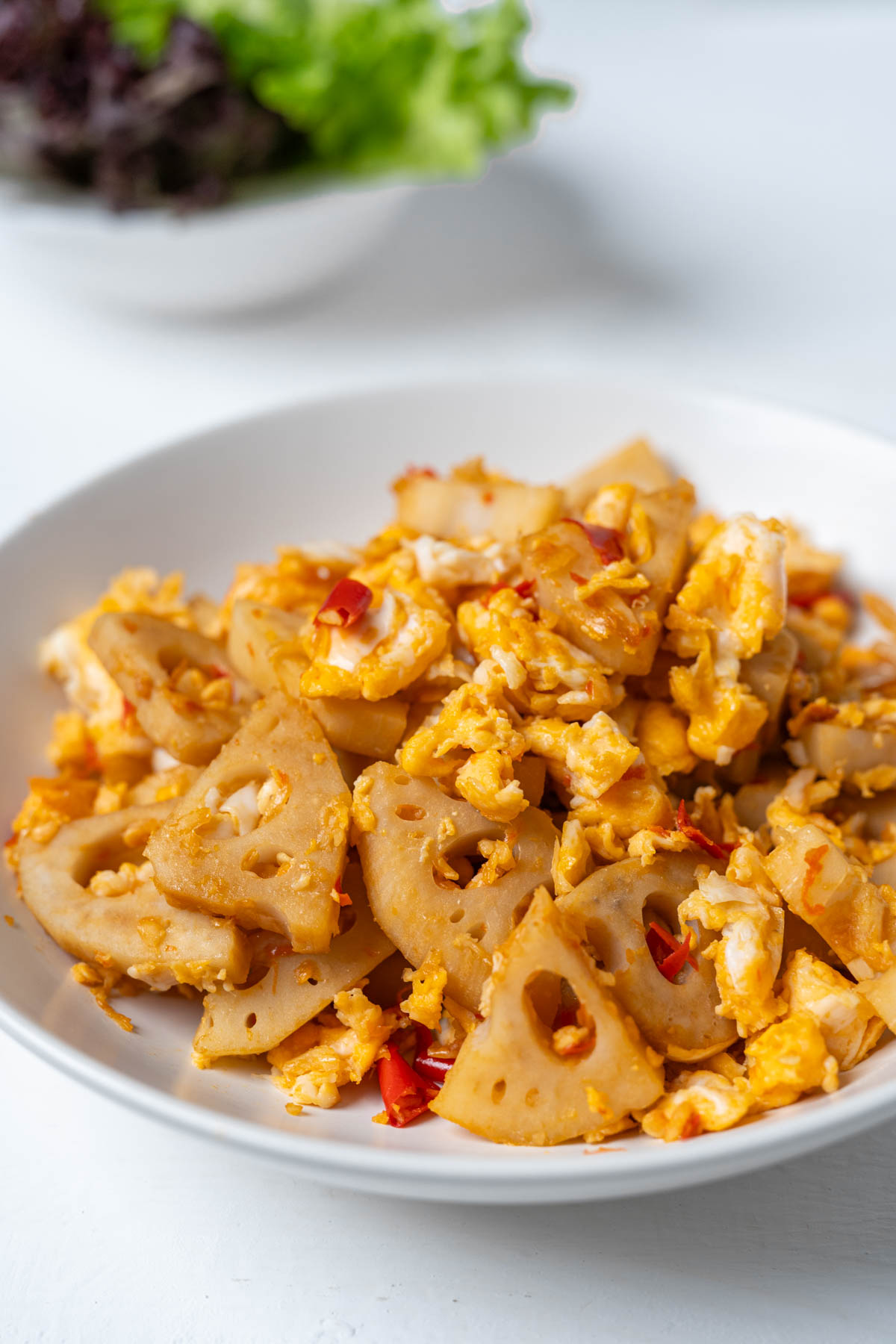 lotus root stir fry in a white dish