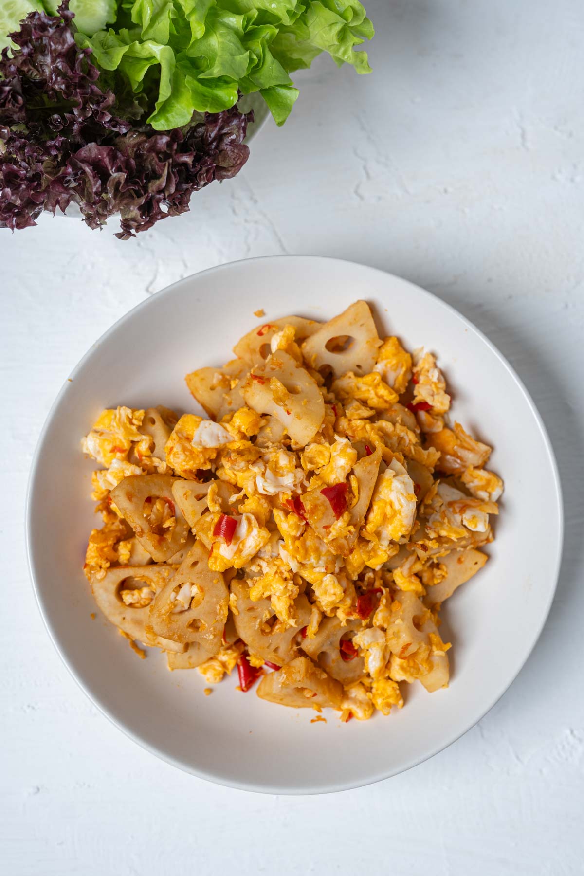 lotus root stir fry in a white dish