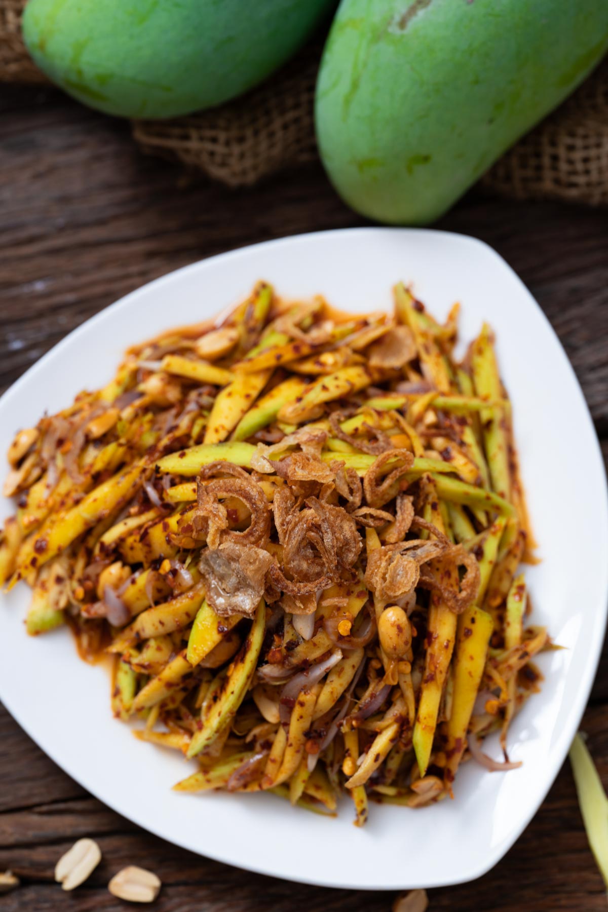Thai green mango salad on a white plate