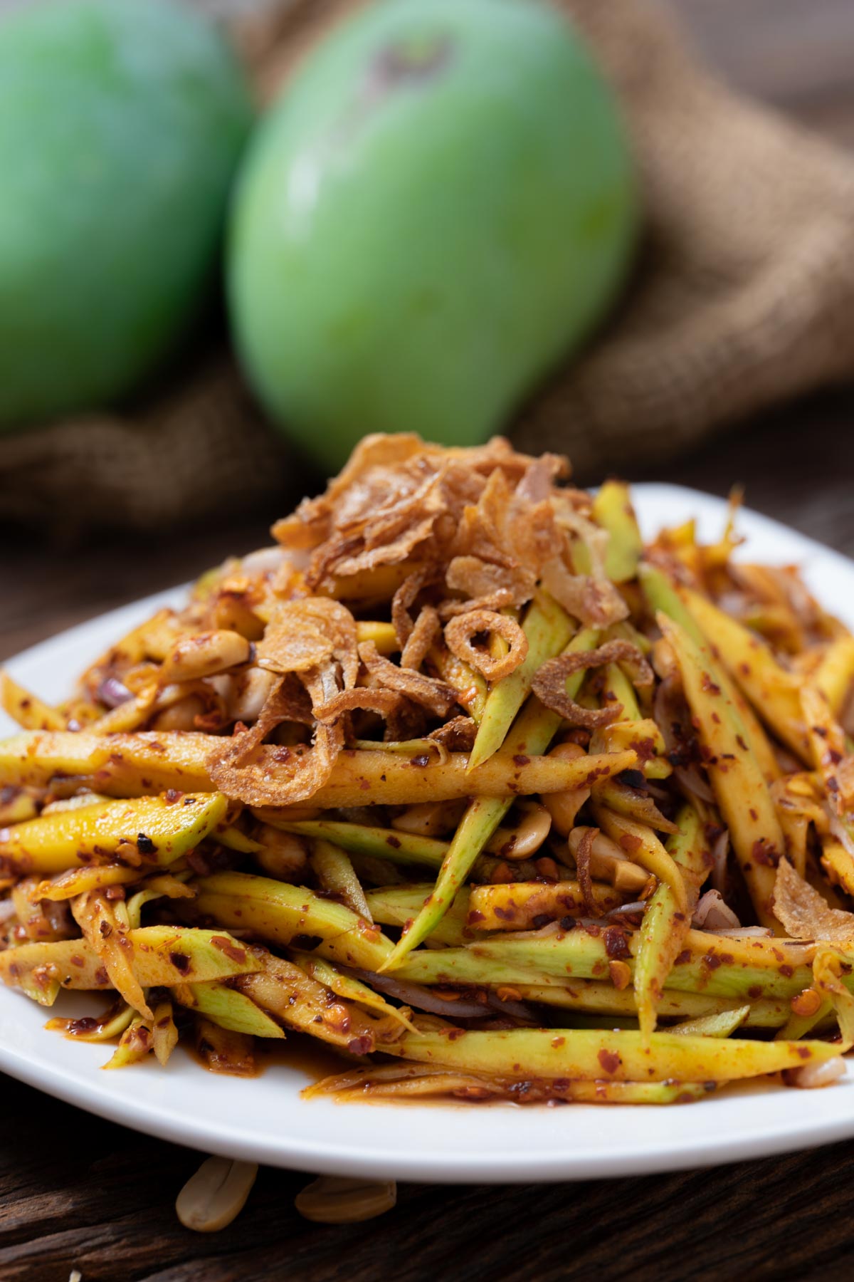Thai green mango salad on a white plate
