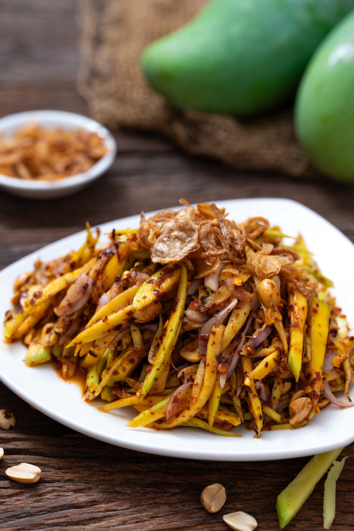 Thai green mango salad on a white plate